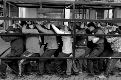Men carry a heavy metal frame during practice for Holy Week processions in Spain
