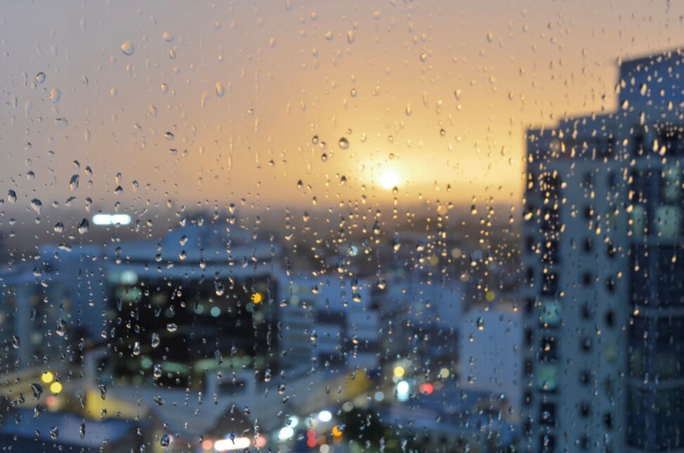 View of Sydney, Australia, at sunset through a rainy window